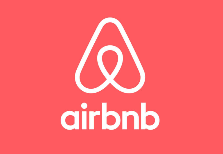 Cultura empresarial y estructura organizativa colaborativa en Airbnb Instrucciones: estilo editorial moderno, espacio de oficina abierta y luminosa con colaboradores diversos trabajando en laptops, elementos de diseño contemporáneo y ambiente creativo, sin texto en la imagen, formato horizontal y de alta resolución.