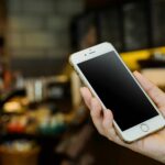 Personas revisando celulares en Cuba con precios elevados por inflación y escasez tecnológica