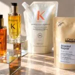 Envases recargables de perfumes y productos de belleza que representan la iniciativa de L’Oréal para reducir residuos y fomentar la reutilización.
