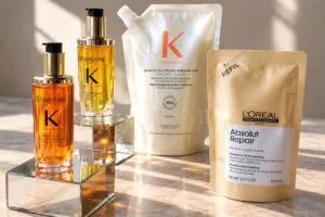 Envases recargables de perfumes y productos de belleza que representan la iniciativa de L’Oréal para reducir residuos y fomentar la reutilización.